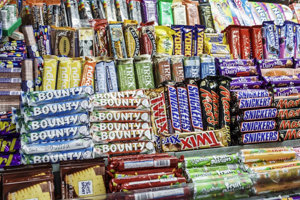 a variety of chocolates and candy stacked in a store