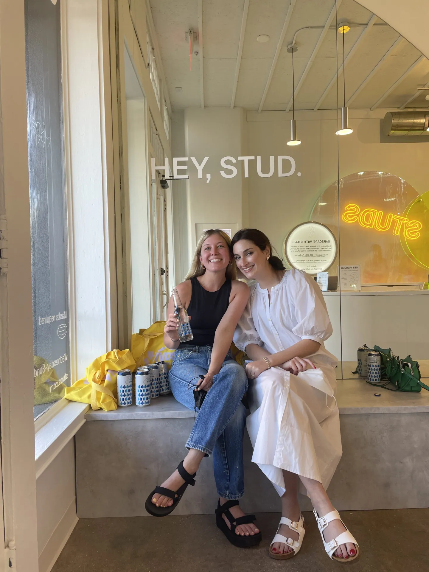 Studs founders Anna Harman and Lisa Bubbers sitting near a window