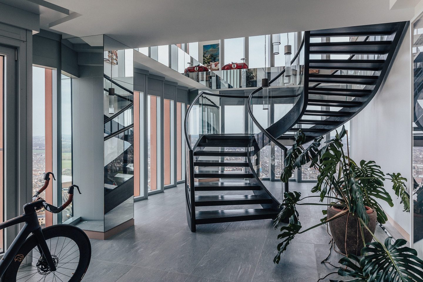 The entrance features a winding iron staircase that leads up to the open-plan primary living space. US-based architect Alex Gorlin undertook the interior design. 