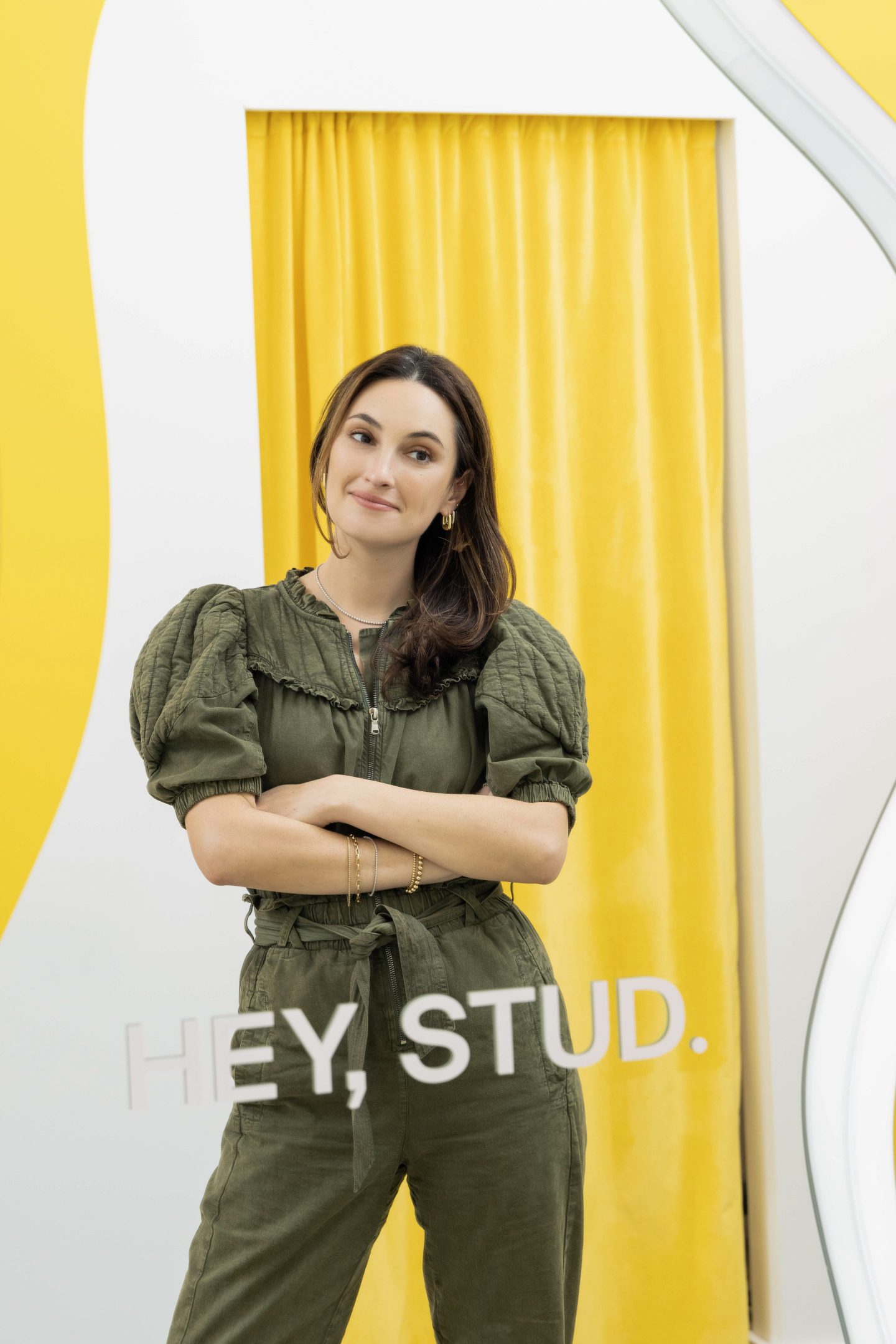 Studs founder Anna Harman in front of a yellow curtain